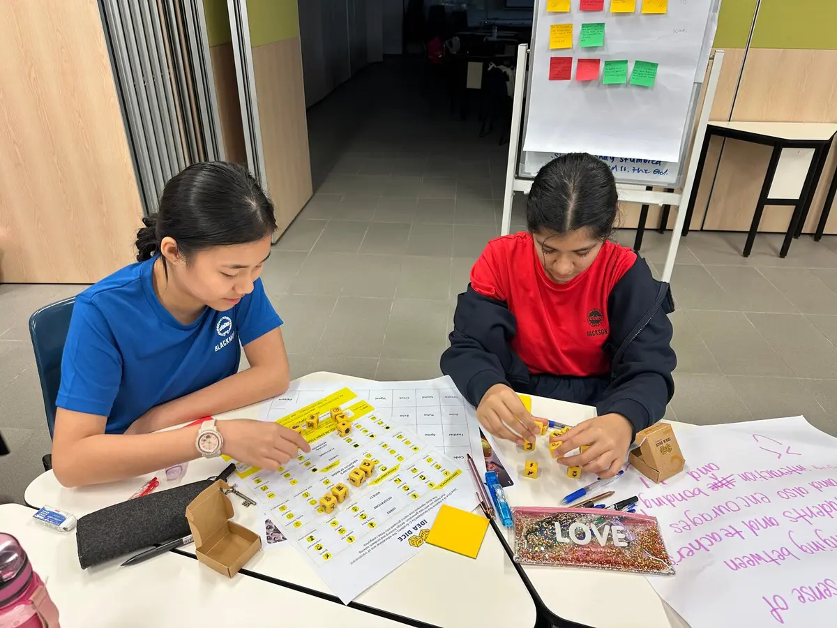 Students using Idea Dice for idea dumping in a design thinking ideation workshop